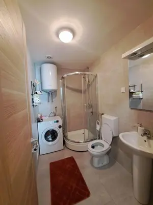 a bathroom with a shower and a toilet and a sink at VUCETIC Apartment- Podgorica in Podgorica