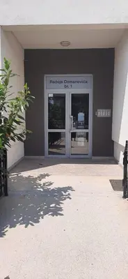 a front door of a building with a window at VUCETIC Apartment- Podgorica in Podgorica