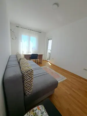 a living room with a couch and a table at VUCETIC Apartment- Podgorica in Podgorica