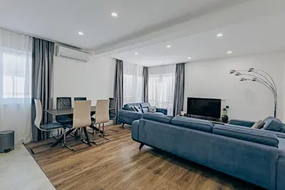 a living room with a blue couch and a table at Bečići lux in Ivanovići