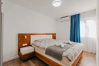 a bedroom with a bed with two teddy bears on it at Bečići lux in Ivanovići