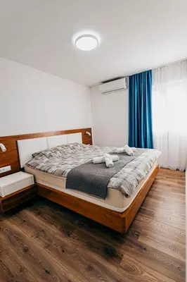 a bedroom with a bed with towels on it at Bečići lux in Ivanovići