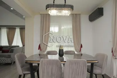 a dining room with a table and chairs at Vila Mikeli in Podgorica