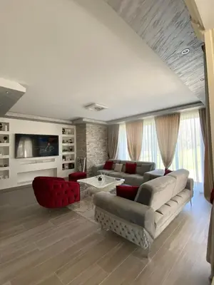 a living room with a couch and a table at Vila Mikeli in Podgorica