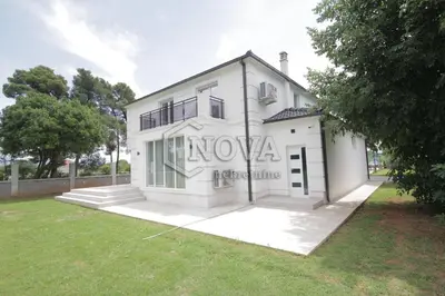 a white building with the word nova on it at Vila Mikeli in Podgorica