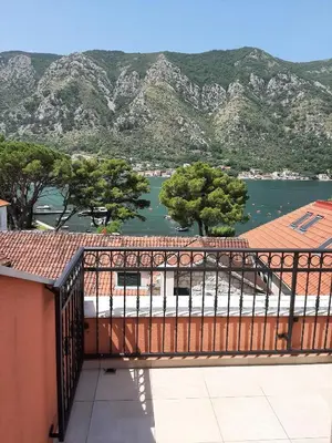 a balcony with a view of the water and mountains at Beautiful flat with sea view Aquamarine in Kotor