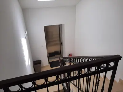 a stairway with a black railing and a mirror at Beautiful flat with sea view Aquamarine in Kotor
