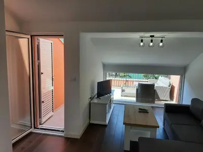a living room with a couch and a tv at Beautiful flat with sea view Aquamarine in Kotor