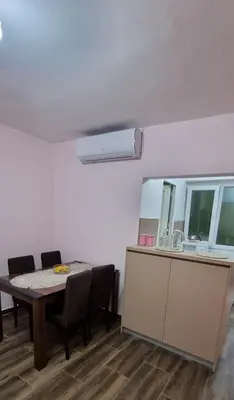 a dining room with a table and chairs and a sink at Apartman Jelena in Cetinje