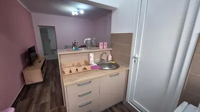a small kitchen with a sink and a counter at Apartman Jelena in Cetinje