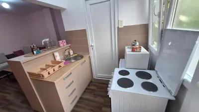 a toy kitchen with a sink and a stove at Apartman Jelena in Cetinje