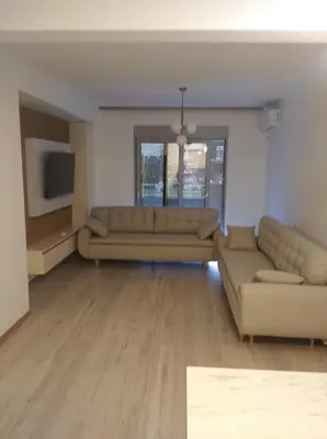 a living room with two couches and a tv at Apartments Exclusive in Ulcinj