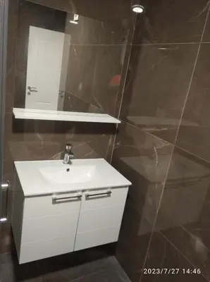 a bathroom with a white sink and a mirror at Apartments Exclusive in Ulcinj
