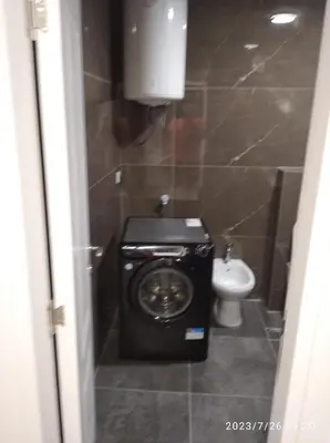 a bathroom with a washing machine and a toilet at Apartments Exclusive in Ulcinj
