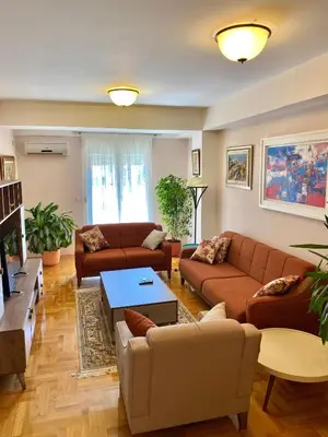 a living room with two couches and a table at Danilo's apartment in Podgorica