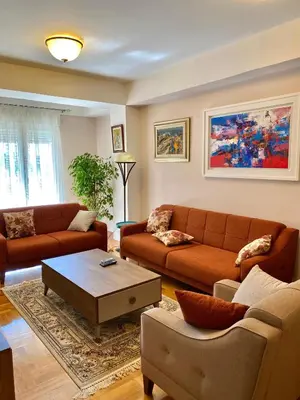 a living room with two couches and a coffee table at Danilo's apartment in Podgorica