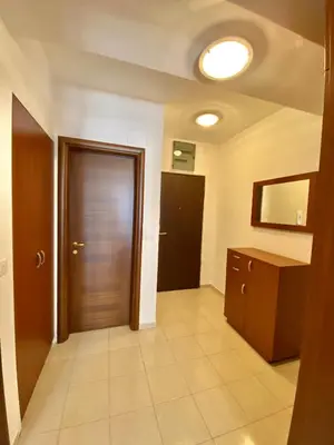 a hallway with a door and a tiled floor at Danilo's apartment in Podgorica