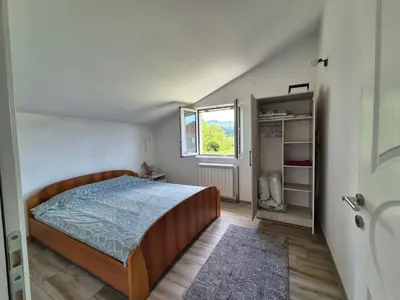 a bedroom with a bed and a window at Peaceful 2BR Apt with Ultra-Fast WiFi in Podgorica