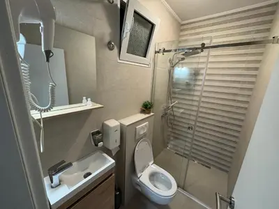 a bathroom with a toilet and a sink and a shower at Apartments Marilu in Kotor