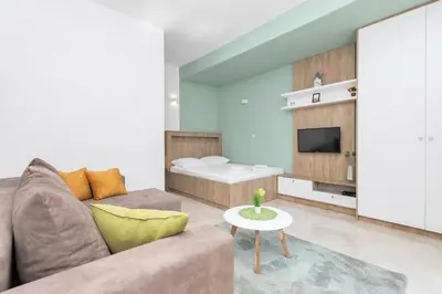 a living room with a couch and a bed at Apartments Marilu in Kotor