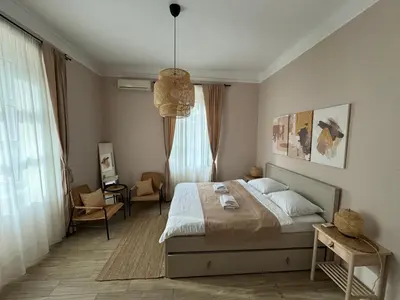a bedroom with a bed and a chair and a window at Apartments Marilu in Kotor