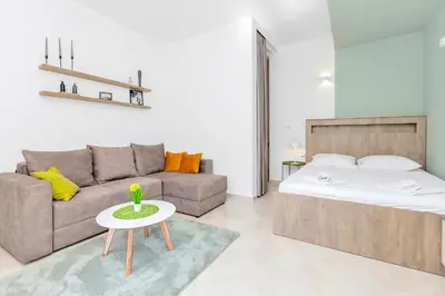 a living room with a bed and a couch at Apartments Marilu in Kotor