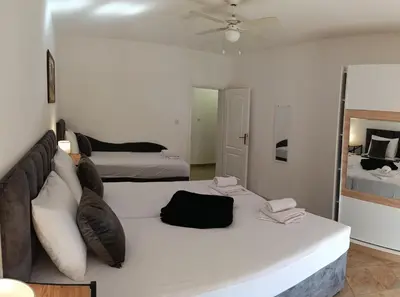 a bedroom with a large bed and a mirror at TEA7 apartment in Kotor