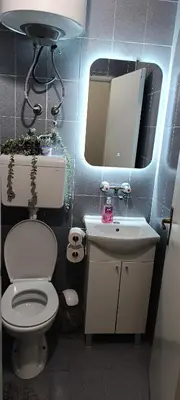 a bathroom with a toilet and a sink and a mirror at TEA7 apartment in Kotor