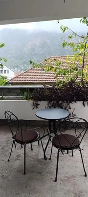 a table and two chairs sitting next to a window at TEA7 apartment in Kotor