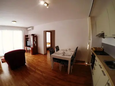 a kitchen and dining room with a table and chairs at Montetrest Apartments in Sveti Stefan