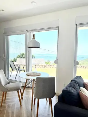 a living room with a couch and a table at Bungalow for 2 - Dream Oasis Dobra Voda in Dobra Voda