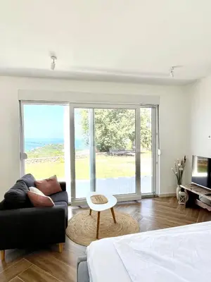 a living room with a bed and a couch at Bungalow for 2 - Dream Oasis Dobra Voda in Dobra Voda