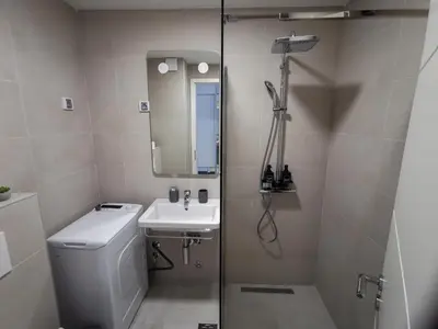 a bathroom with a shower and a toilet and a sink at Apartments Radovic in Podgorica