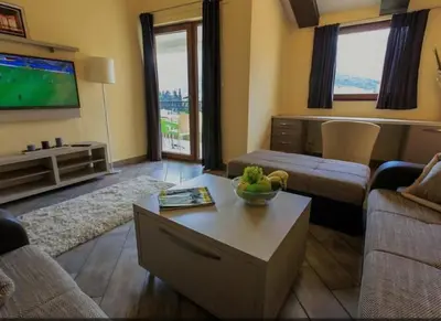a living room with a couch and a tv at At Oliver’s in Budva