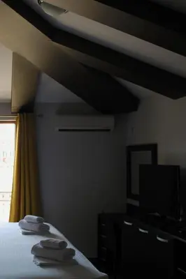 a bedroom with a bed with two towels on it at At Oliver’s in Budva