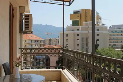 a balcony with a table and a view of a city at At Oliver’s in Budva