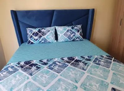 a bed with a blue headboard and two pillows at Apartment Blue Utjeha Hladna uvala in Kruče