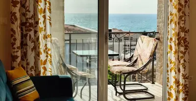 a room with a balcony with a table and chairs at Apartment Blue Utjeha Hladna uvala in Kruče