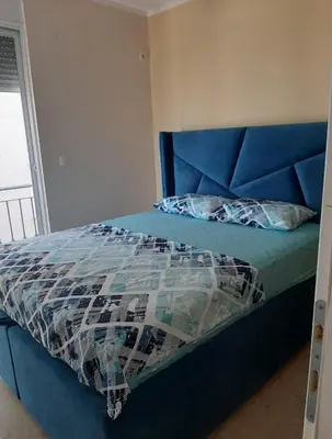 a blue bed with a blue headboard in a bedroom at Apartment Blue Utjeha Hladna uvala in Kruče