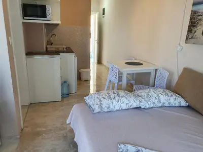 a room with a bed and a table and a kitchen at Stadjorluk Hladna uvala in Kruče