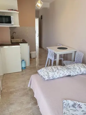 a room with a table and a table and a kitchen at Stadjorluk Hladna uvala in Kruče