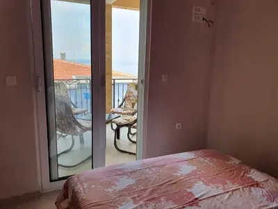 a bedroom with a view of a balcony with a bed at Stadjorluk Hladna uvala in Kruče