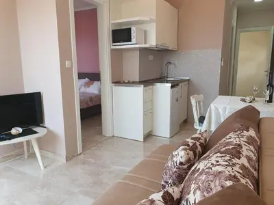 a living room with a couch and a kitchen at Stadjorluk Hladna uvala in Kruče