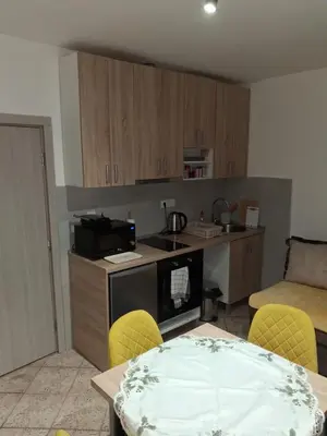 a small kitchen with a table and a microwave at apartman19 in Podgorica
