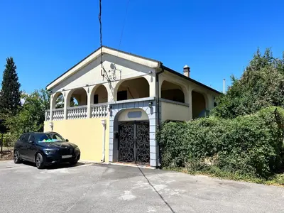 a building with a car parked in front of it at Central Park Apartment in Podgorica