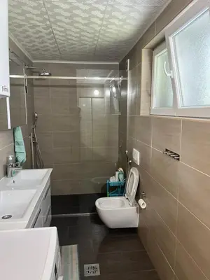 a bathroom with a toilet and a sink at Central Park Apartment in Podgorica
