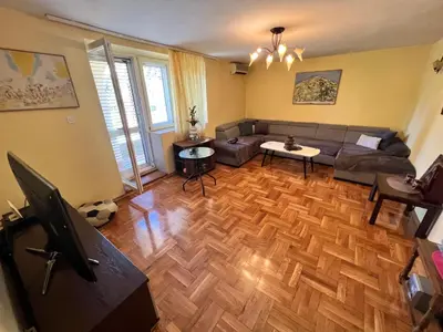 a living room with a couch and a table at Central Park Apartment in Podgorica