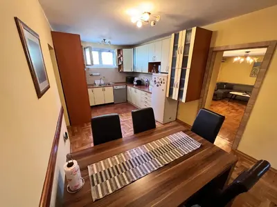 a kitchen and dining room with a table and chairs at Central Park Apartment in Podgorica