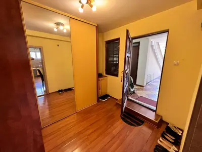 an empty living room with yellow walls and wooden floors at Central Park Apartment in Podgorica