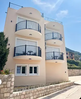 a building with balconies on the side of it at Apartments HAS in Kotor